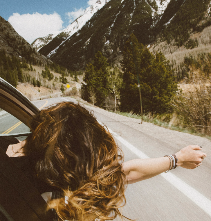 Woman enjoying a road trip in a car